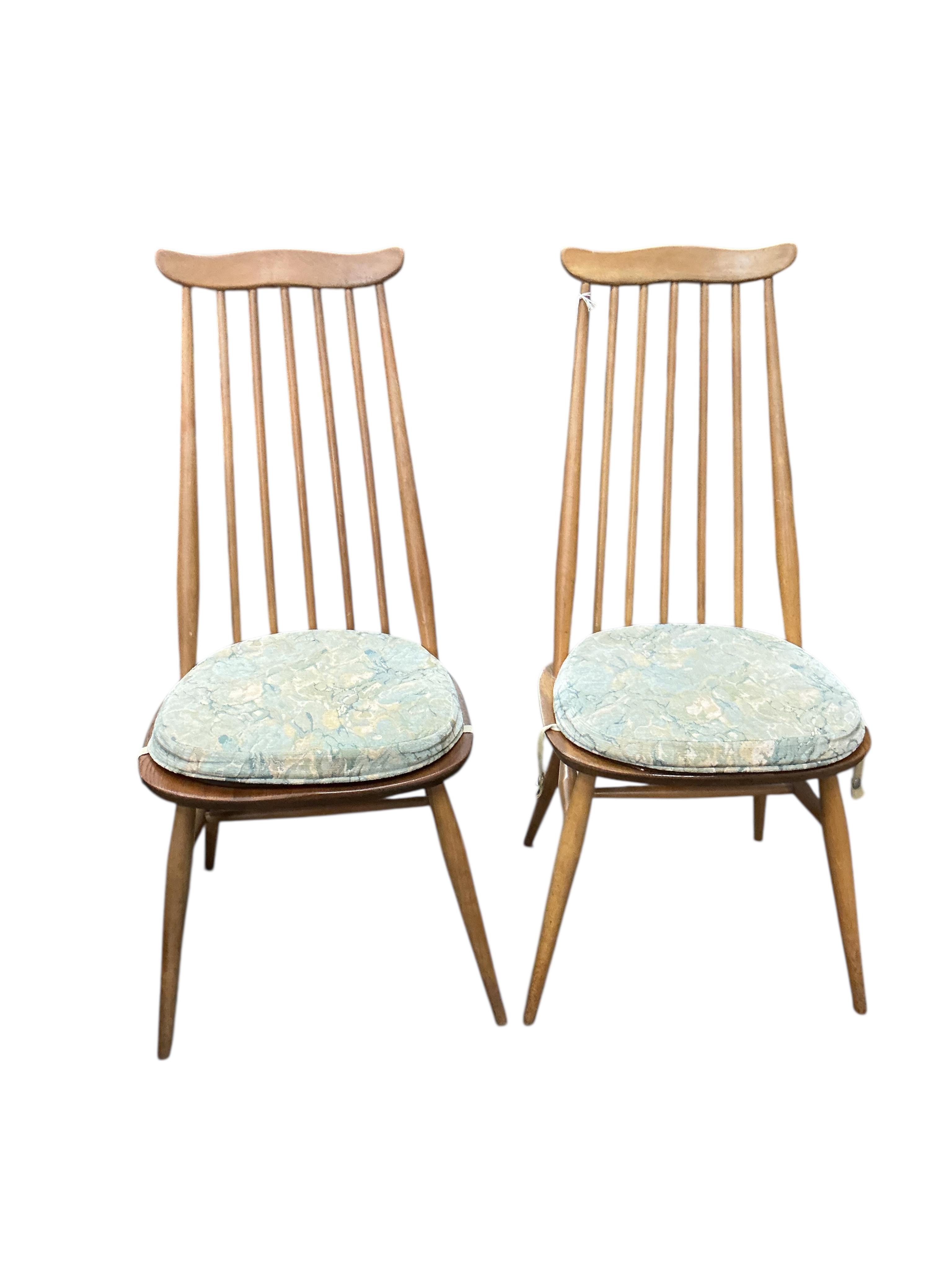 An Ercol elm and beech drop leaf dining table, width 112cm, depth 62cm, height 72cm and four Ercol elm and beech comb back dining chairs